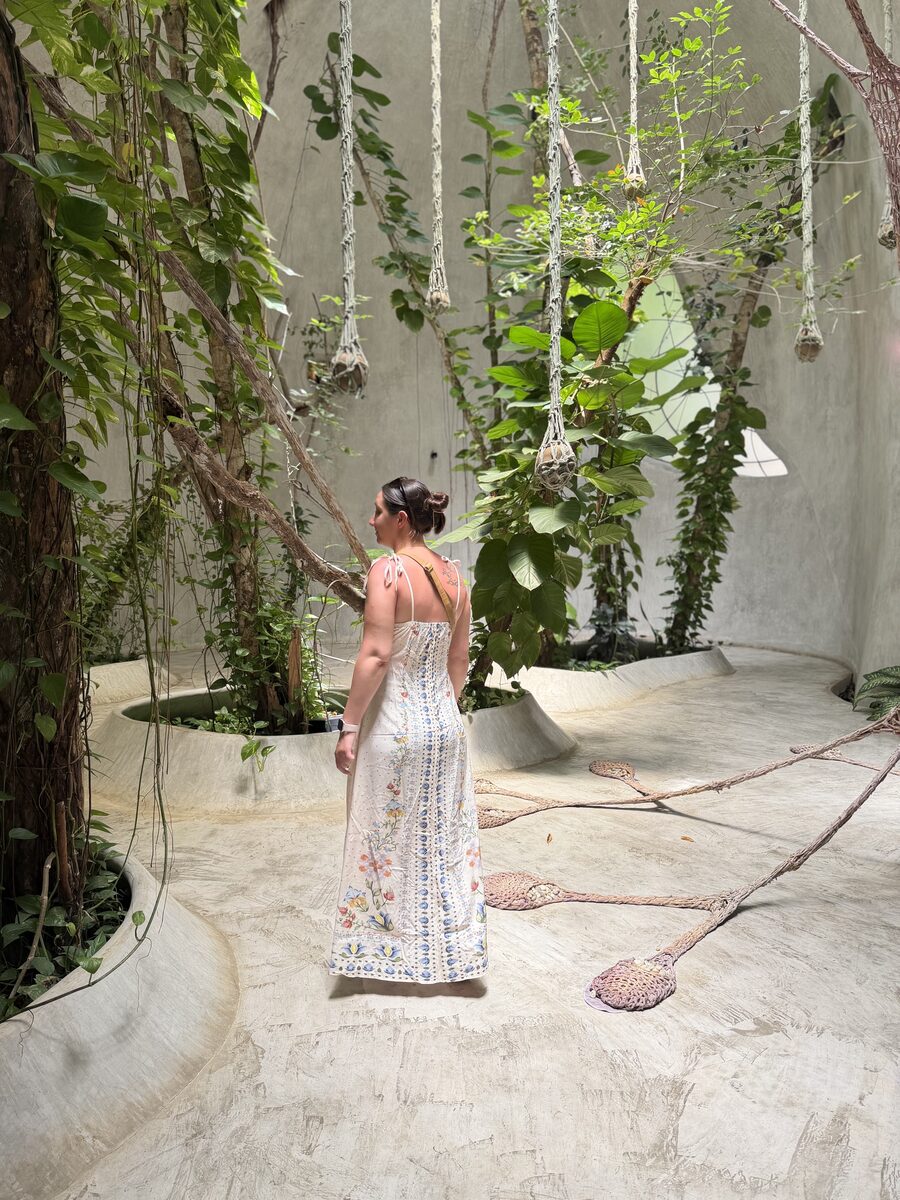 Amanda, owner of Hummingbird Cleaning Solutions, among lush greenery